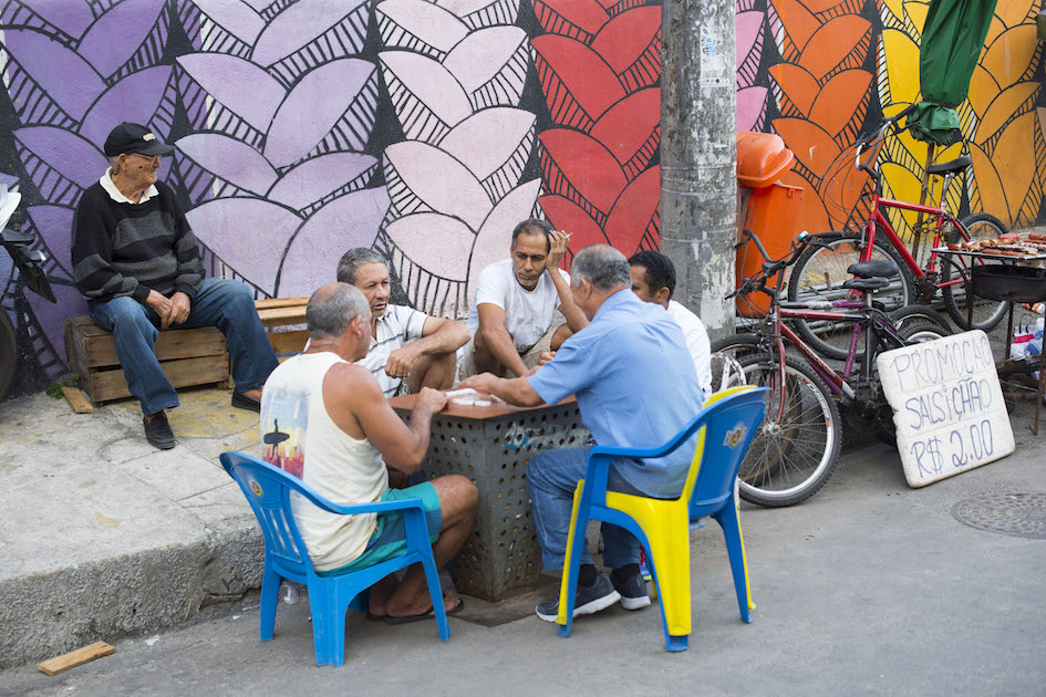 Men playing dominoes on the streets of the Santa Marta Favela, Rio de Janerio.