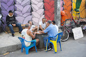 Men playing dominoes on the streets of the Santa Marta Favela, Rio de Janerio.