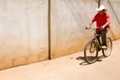 Man rides his bike down the streets of Utila