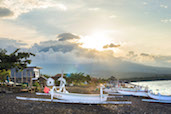 The last rays of sun on the sleepy beach of Amed before it sets behind Mt. Agung, Bali