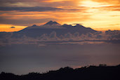 The sunrise over Lombok’s volcano Mt. Rinjani seen from the top of Bali’s volcano Mt. Batur
