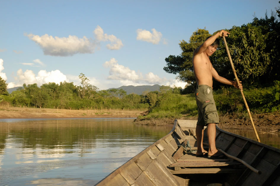 Man rows a boat down the Mekong