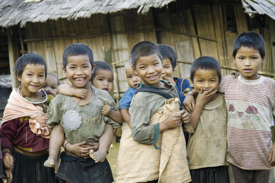 Akha kids babysitting their siblings while the adults work the fields