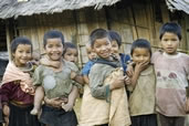 Akha kids babysitting their siblings while the adults work the fields