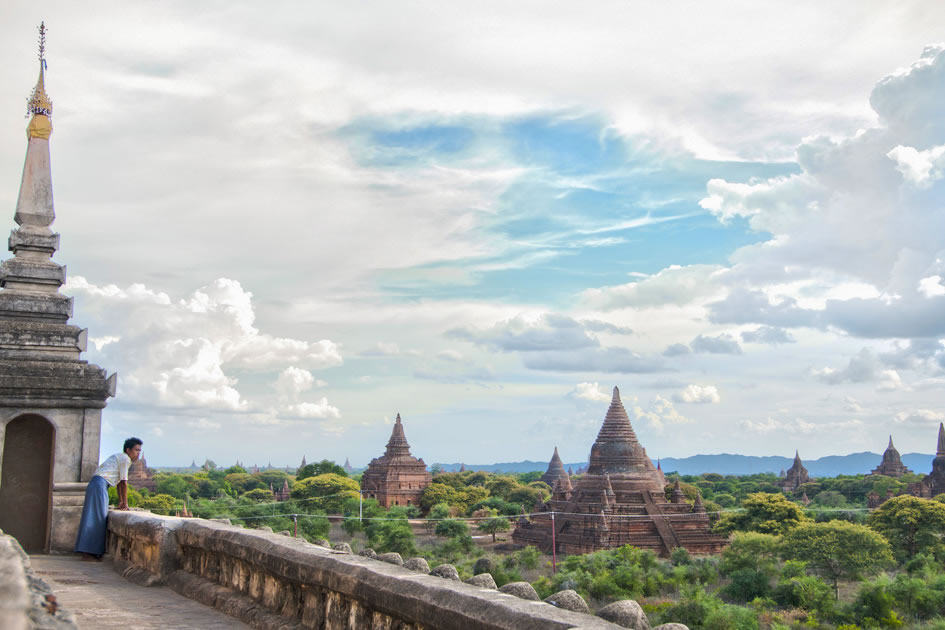 Burmese man looks out over the ancient temples, Bagan